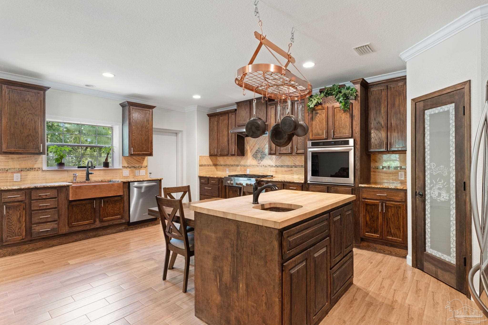 6781 Generals Lane Pace, FL 32571 - Photo 11 of 35 a kitchen with a sink a counter top space appliances and cabinets
