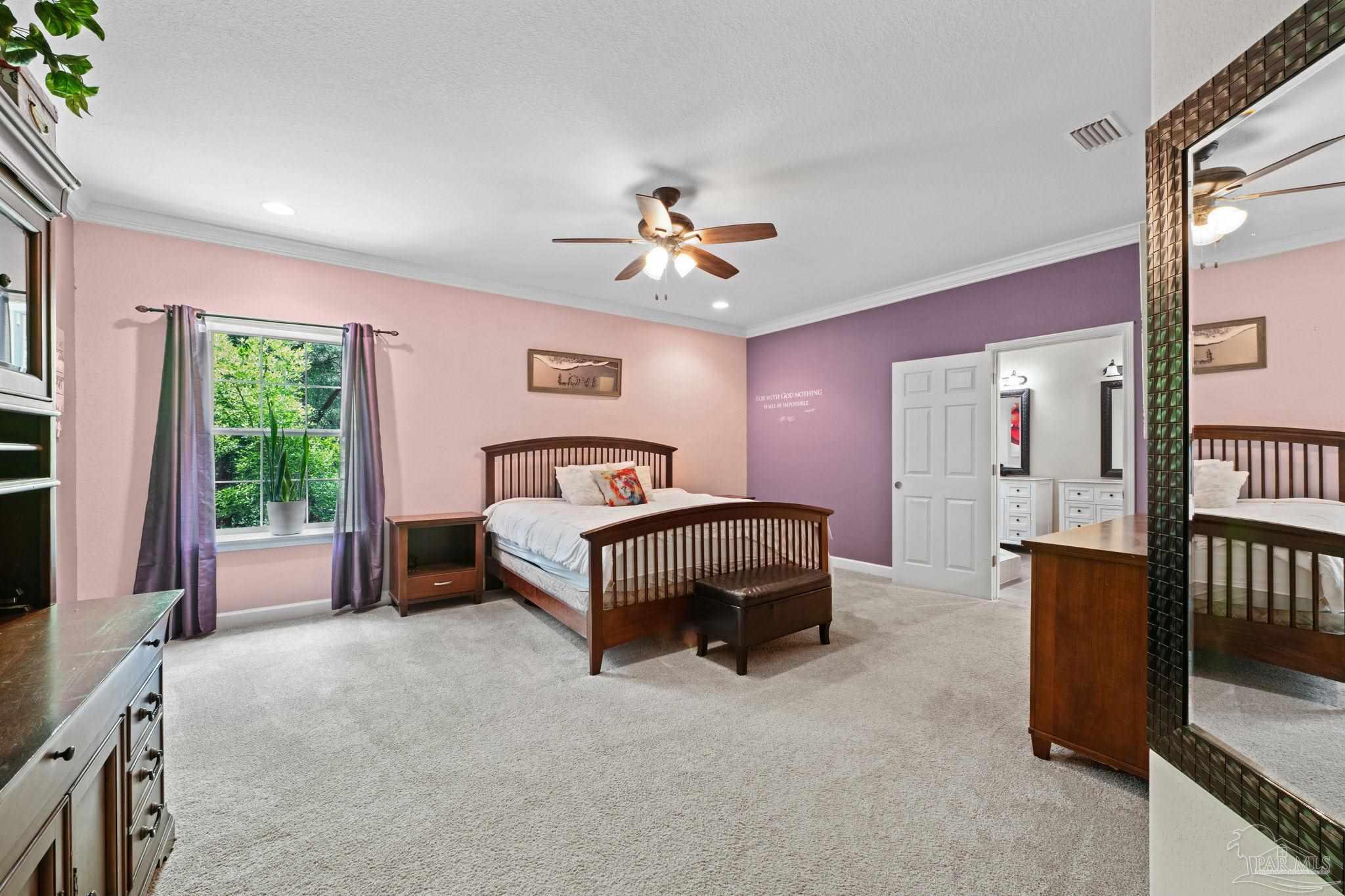 6781 Generals Lane Pace, FL 32571 - Photo 12 of 35 a bedroom with a bed and a chandelier