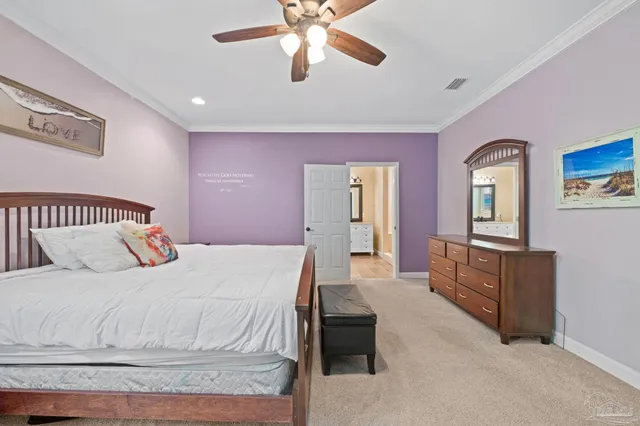 a bedroom with a bed and dresser with mirror