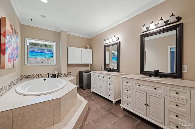 a spacious bathroom with 2 sink tub and a mirror