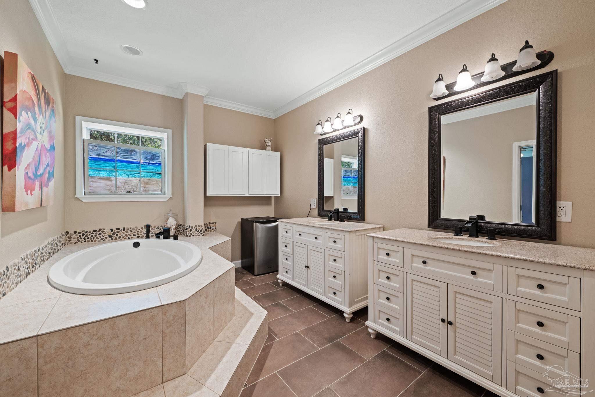 6781 Generals Lane Pace, FL 32571 - Photo 15 of 35 a spacious bathroom with 2 sink tub and a mirror