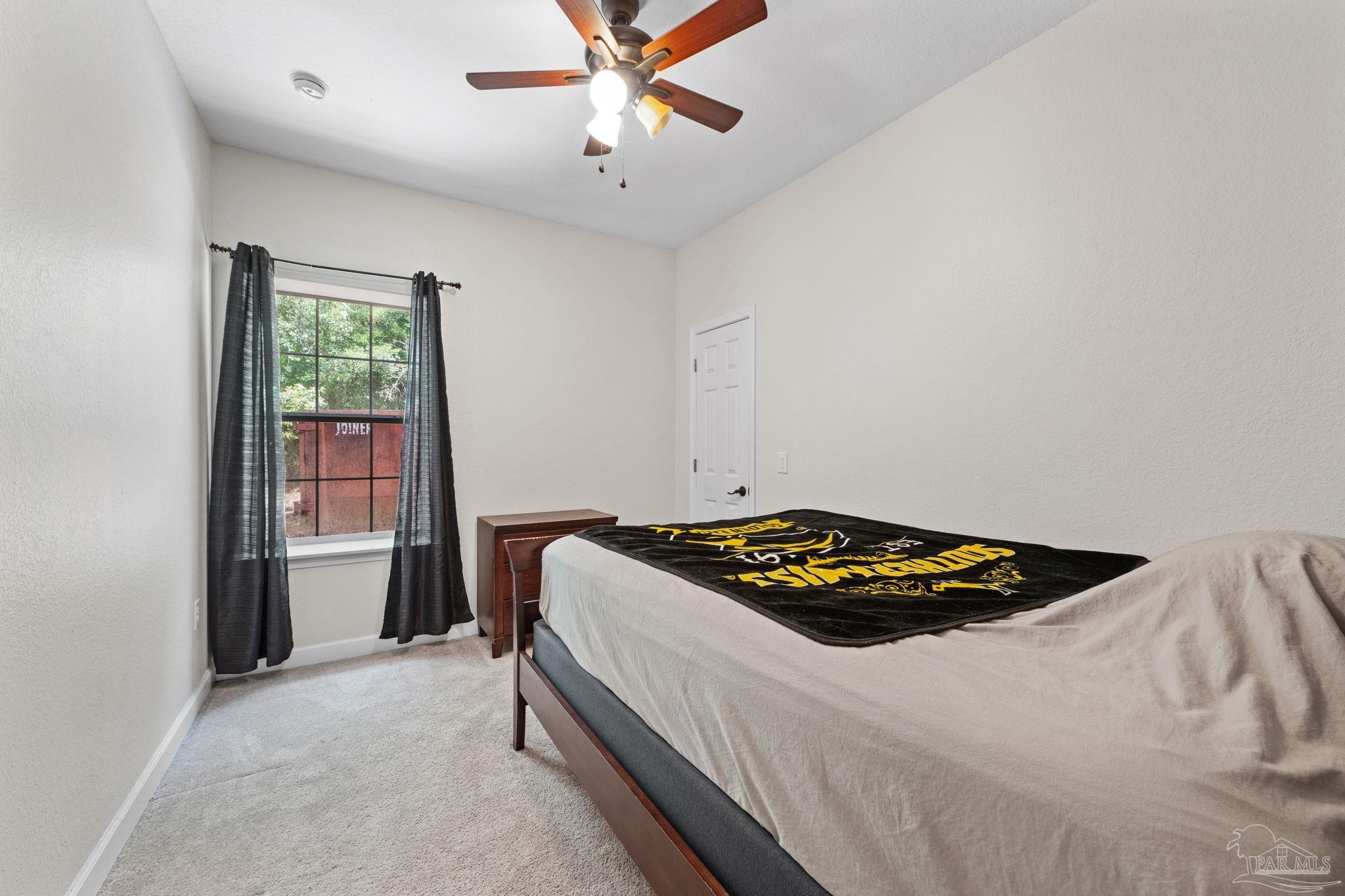 6781 Generals Lane Pace, FL 32571 - Photo 18 of 35 a bedroom with a bed and a window