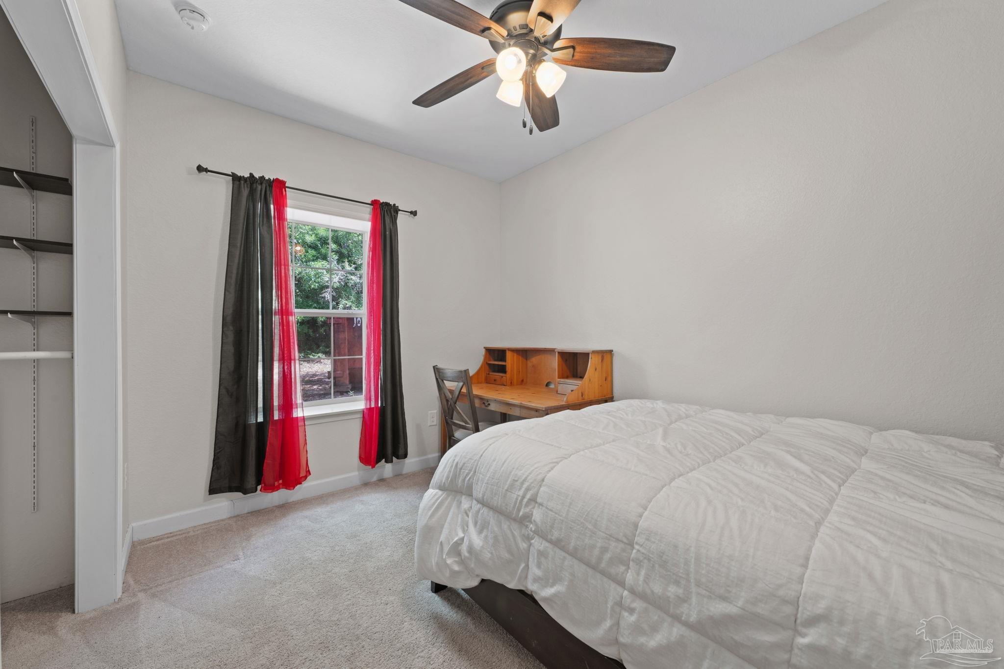 6781 Generals Lane Pace, FL 32571 - Photo 19 of 35 a bedroom with a bed and a chandelier