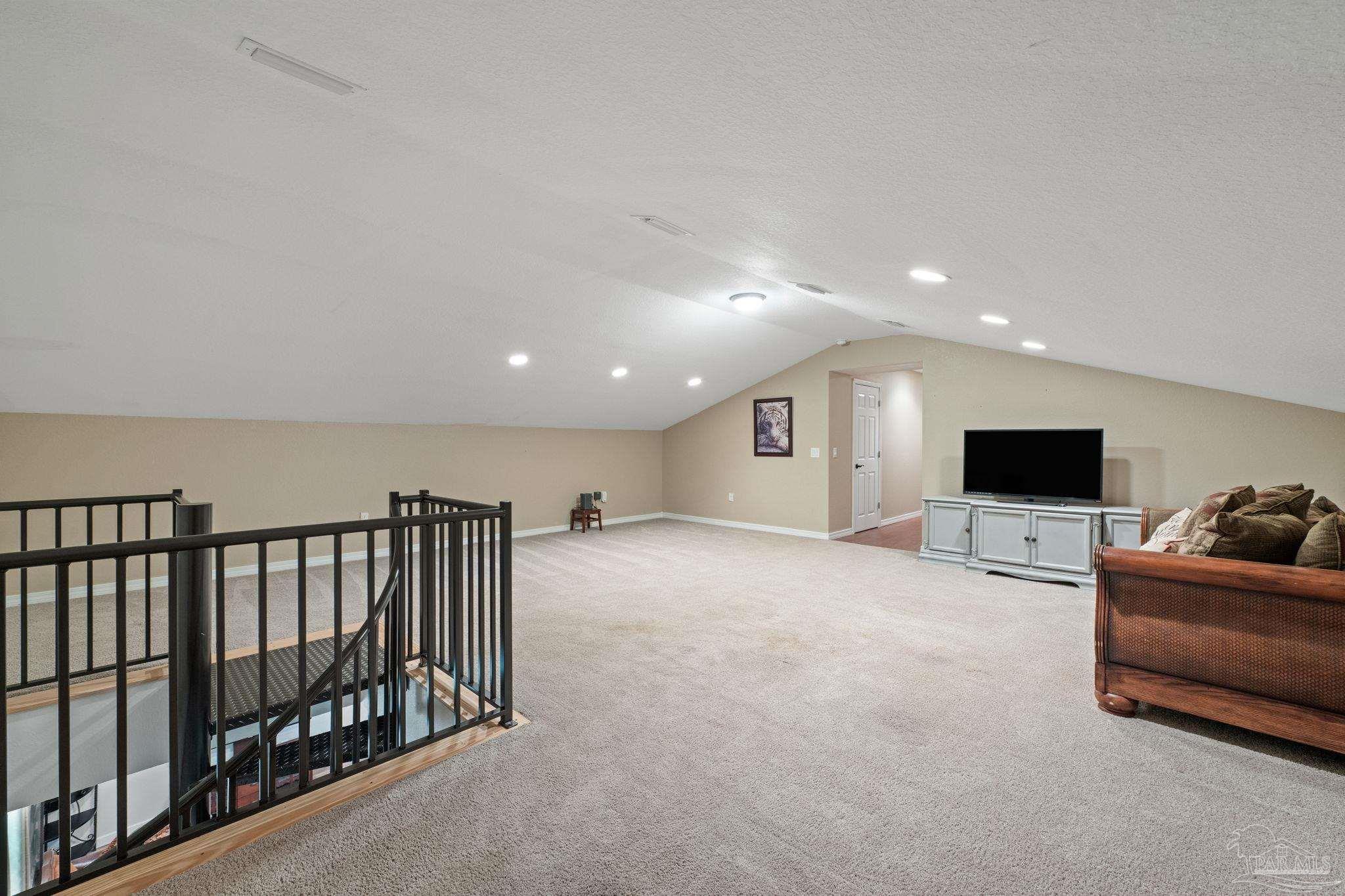 6781 Generals Lane Pace, FL 32571 - Photo 24 of 35 a living room with furniture and a flat screen tv
