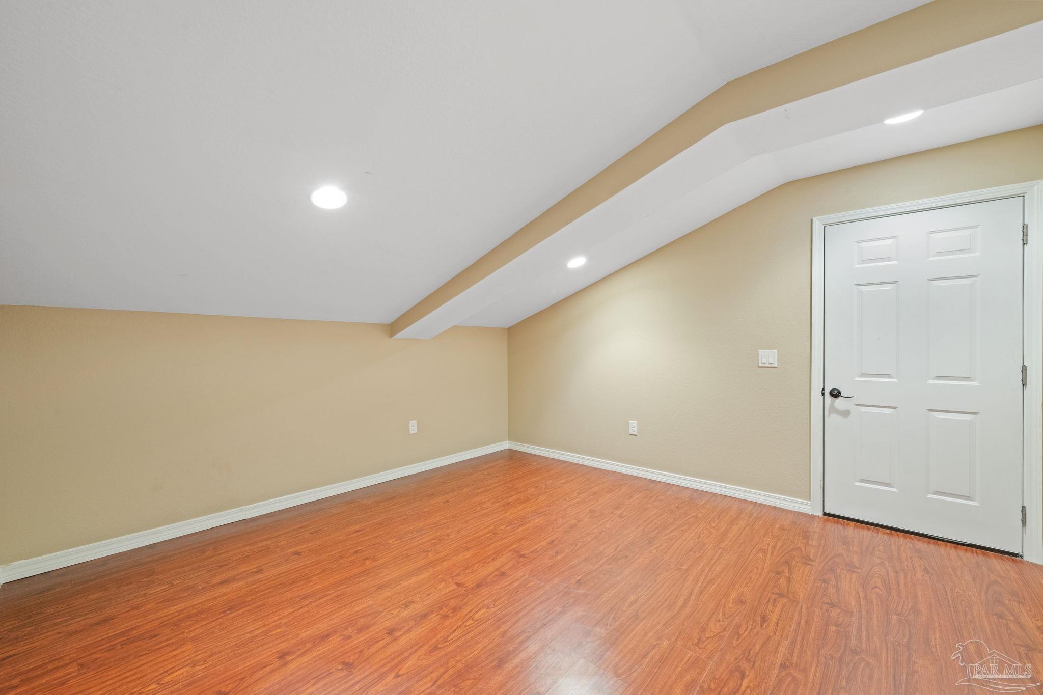 6781 Generals Lane Pace, FL 32571 - Photo 28 of 35 an empty room with wooden floor and windows