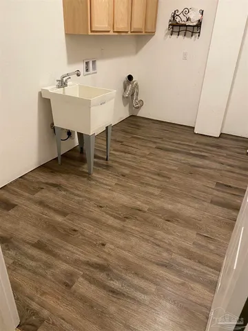 a view of a room with a sink and cabinets