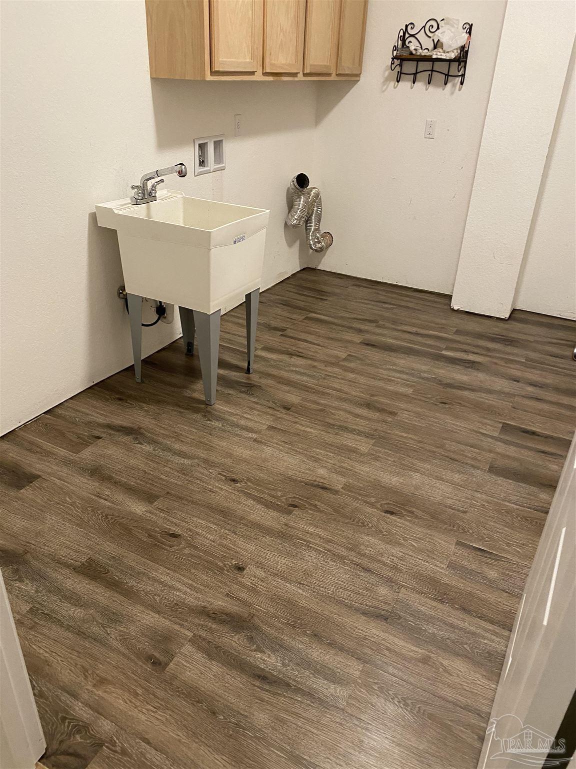 6781 Generals Lane Pace, FL 32571 - Photo 30 of 35 a view of a room with a sink and cabinets