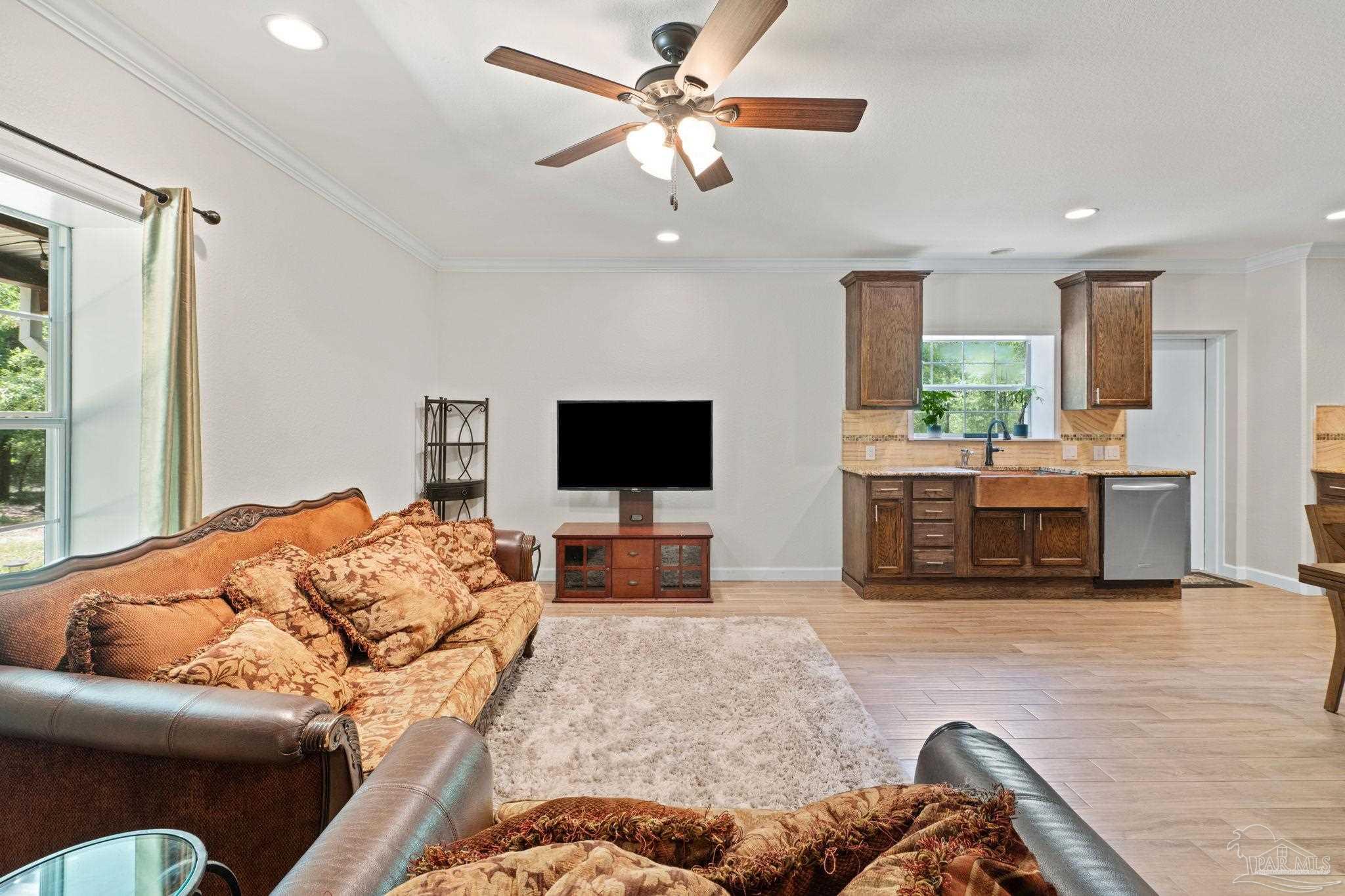 6781 Generals Lane Pace, FL 32571 - Photo 3 of 35 a living room with furniture and a flat screen tv