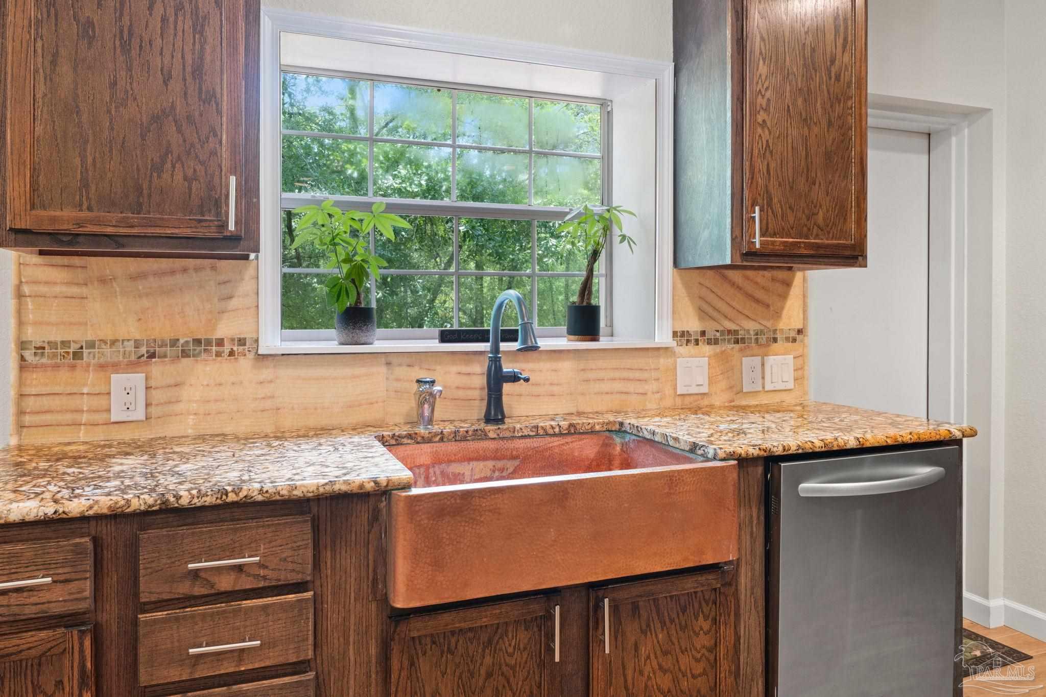 6781 Generals Lane Pace, FL 32571 - Photo 9 of 35 a kitchen with granite countertop sink stove and cabinets