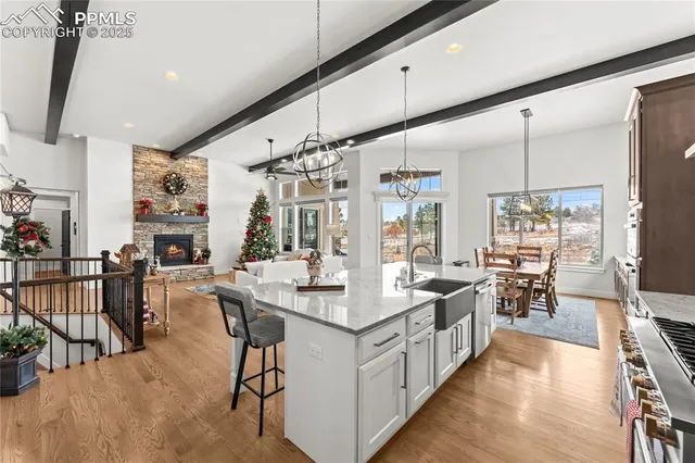 a large white kitchen with lots of counter top space and stainless steel appliances