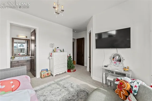 a bedroom with furniture and a flat screen tv