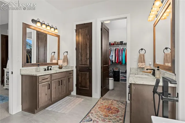 a bathroom with a double vanity sink and a mirror