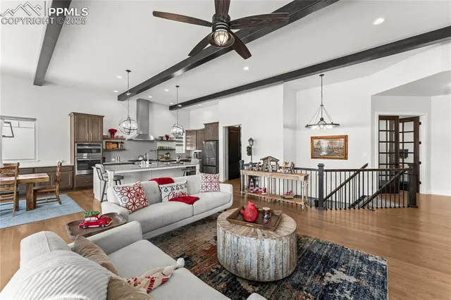 a living room with furniture and kitchen view