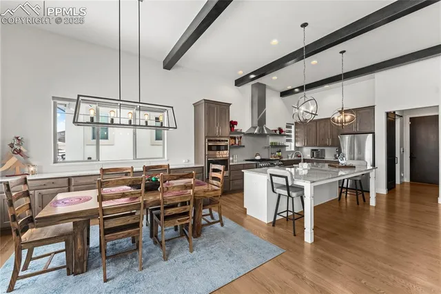 a kitchen with a table chairs stove and cabinets