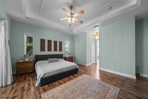 a bedroom with a large bed and a chandelier