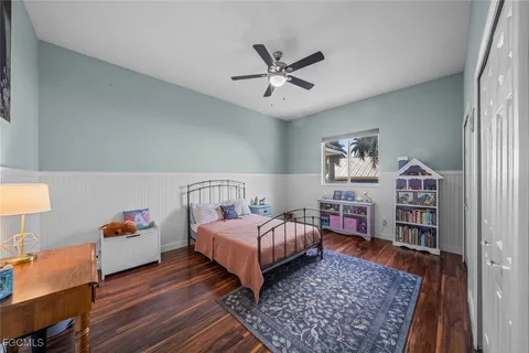 a bedroom with a bed and a bookshelf