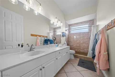 a bathroom with a double vanity sink and a mirror