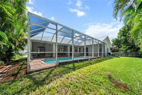 a house view with swimming pool and garden space