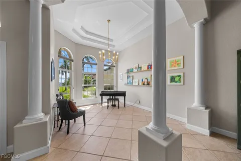 a living room with fireplace furniture and a chandelier