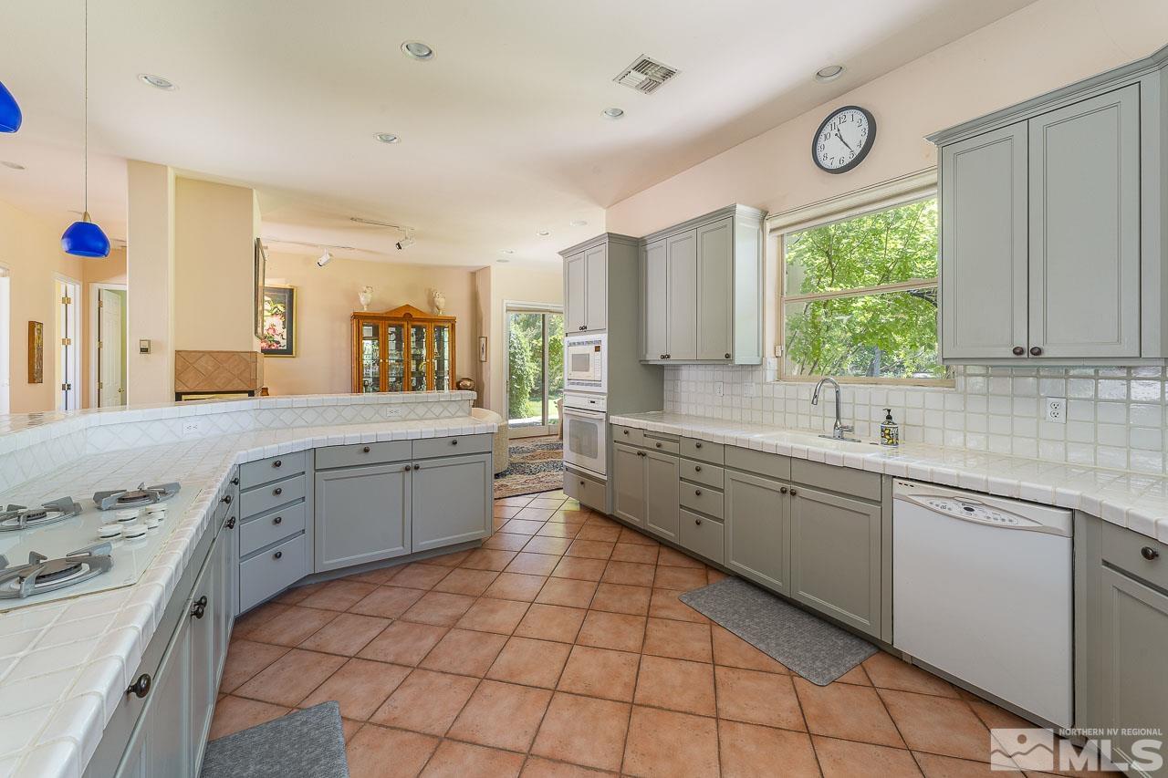 4440 Juniper Trail Reno, NV 89519 - Photo 11 of 29 a large kitchen with a sink and cabinets