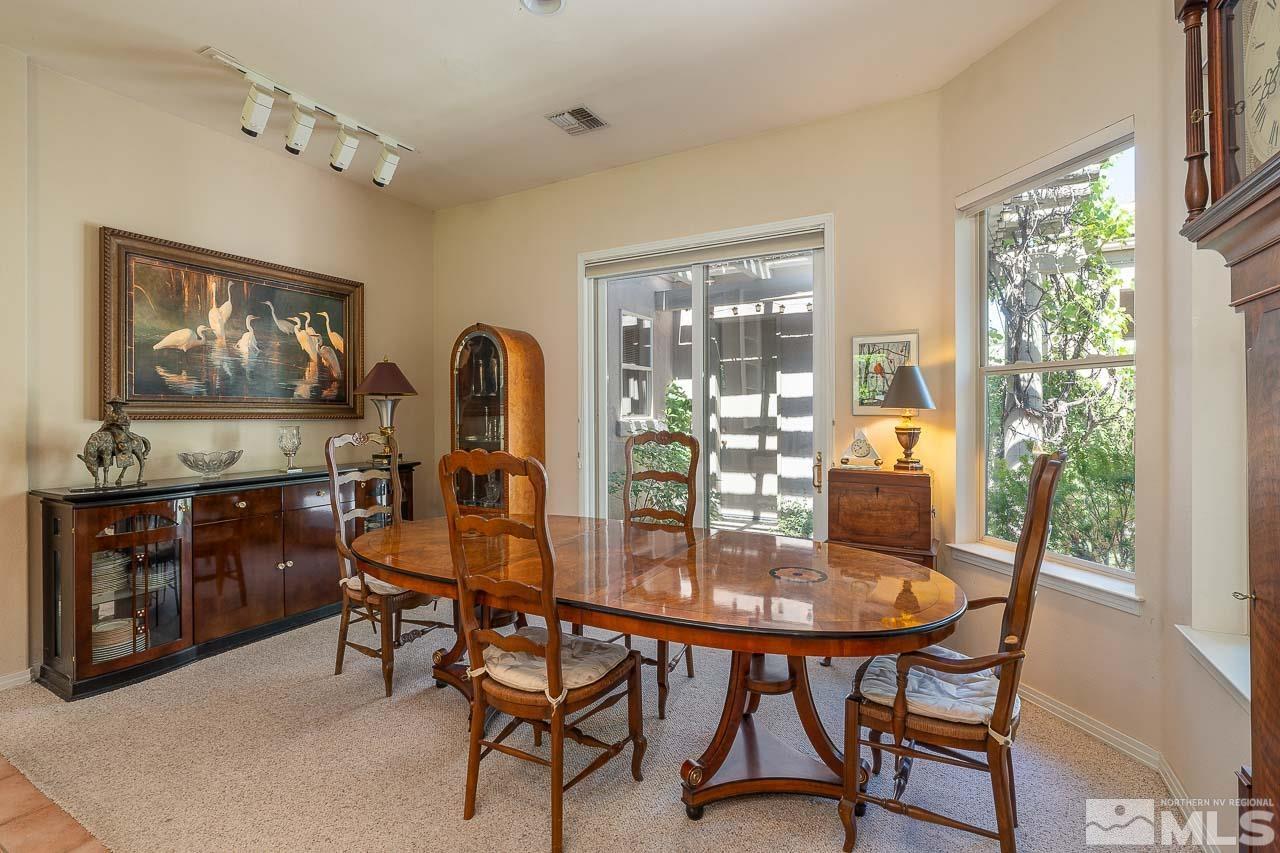 4440 Juniper Trail Reno, NV 89519 - Photo 15 of 29 a dining room with furniture a painting and a chandelier