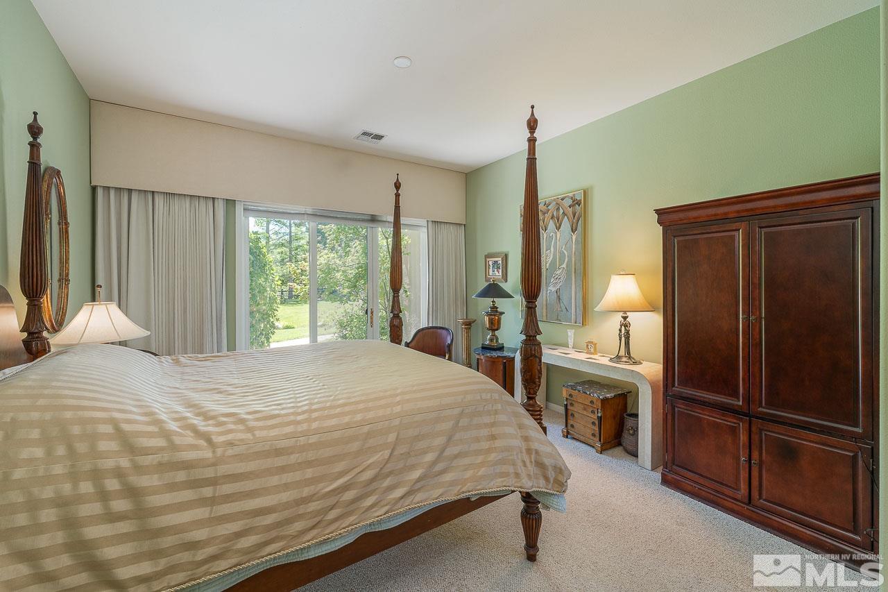 4440 Juniper Trail Reno, NV 89519 - Photo 16 of 29 a bedroom with a bed dresser and a large window