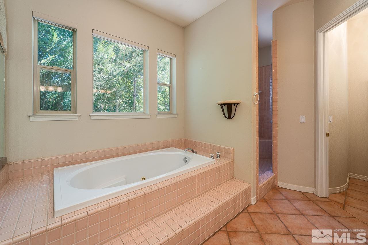 4440 Juniper Trail Reno, NV 89519 - Photo 18 of 29 a bathroom with a bathtub and a shower