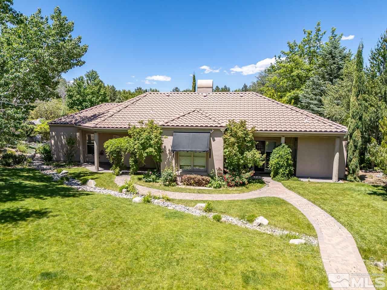 4440 Juniper Trail Reno, NV 89519 - Photo 6 of 29 a view of a house with swimming pool and a yard