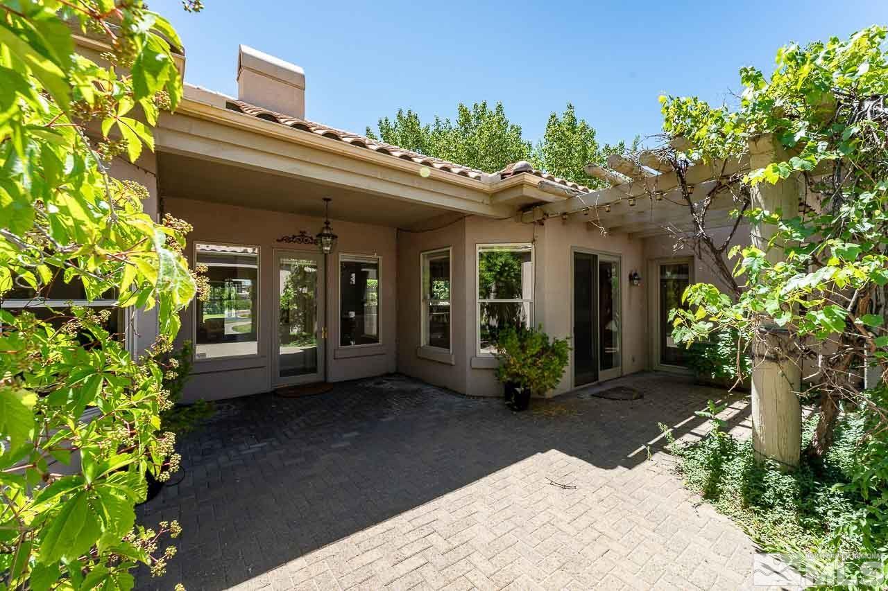 4440 Juniper Trail Reno, NV 89519 - Photo 8 of 29 a view of a house with potted plants and a large tree