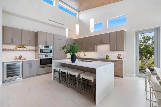 a living room with furniture a floor to ceiling window and floor to ceiling window