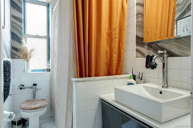 a bedroom with a bed and a book shelf