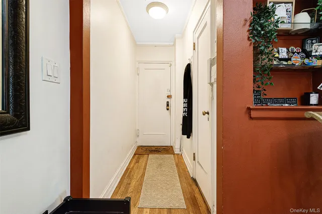 a view of a dining room and livingroom with furniture a rug a potted plant and a chandelier