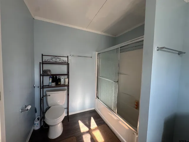 a bathroom with a toilet and a shower