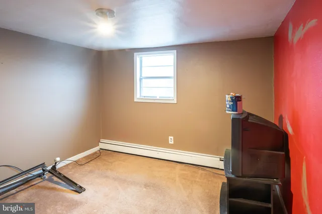a view of a room with gym equipment and a window