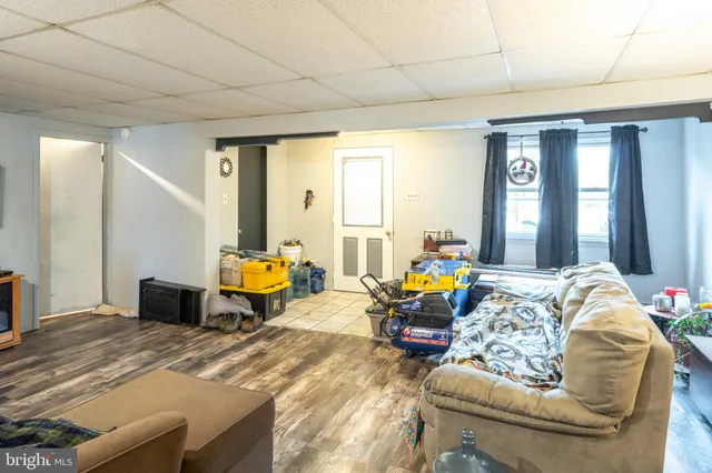 a living room filled with furniture and a chandelier