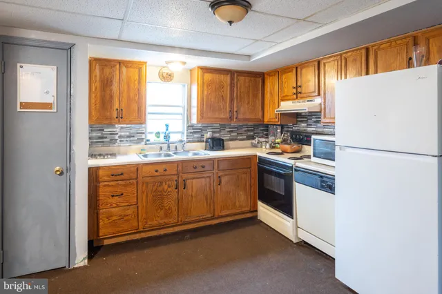 a kitchen with a window a sink and a refrigerator