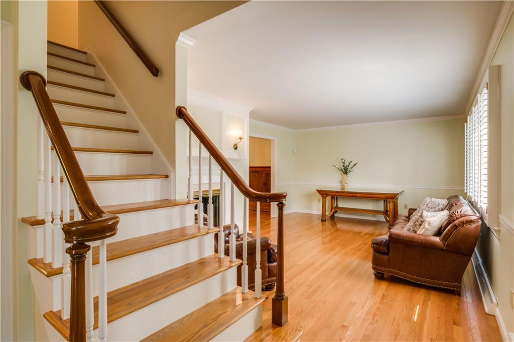 8412 Post Road Allison Park, PA 15101 - Photo 3 of 25 Both floors have gleaming hardwood flooring! The living room is spacious with a fireplace, built in cabinetry and plantation shutters.