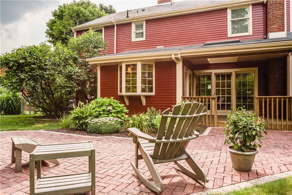 8412 Post Road Allison Park, PA 15101 - Photo 22 of 25 The covered porch has a skylight and the brick patio is surrounded by beautiful flowers and patio trees.
