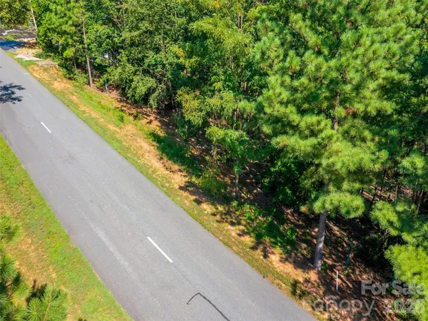 a backyard of a house with yard table and chairs