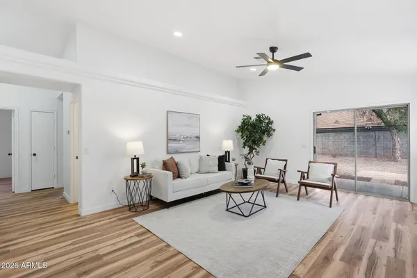 a living room with furniture and a wooden floor