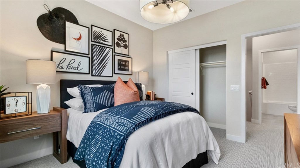 264 Siena Lake Forest, CA 92630 - Photo 16 of 27 a bedroom with a bed and closet with mirror