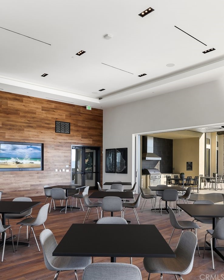 264 Siena Lake Forest, CA 92630 - Photo 21 of 27 a living room with furniture a flat screen tv and kitchen view