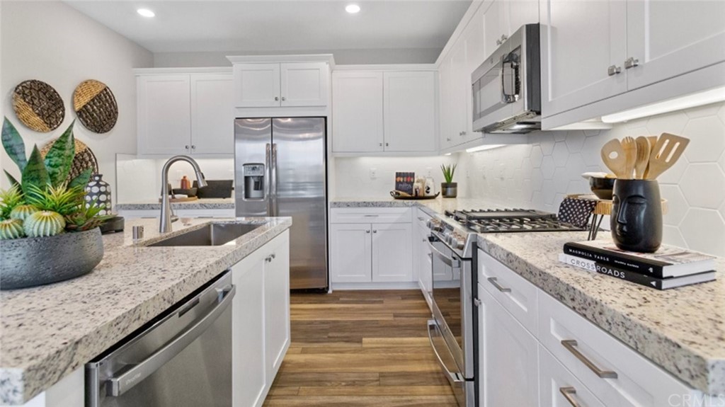 264 Siena Lake Forest, CA 92630 - Photo 7 of 27 a kitchen with granite countertop a sink stainless steel appliances and cabinets