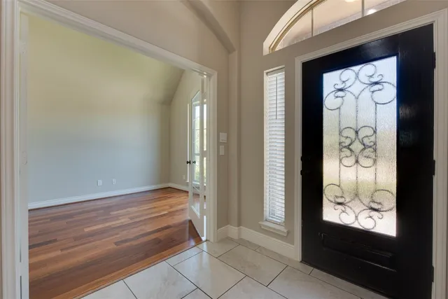 a view of an entryway with wooden floor and door