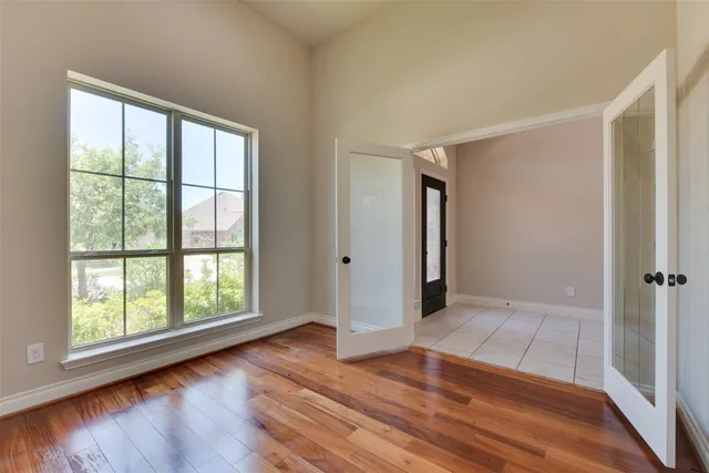 wooden floor in an empty room with a window