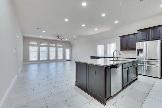 a kitchen with stainless steel appliances granite countertop a sink and cabinets