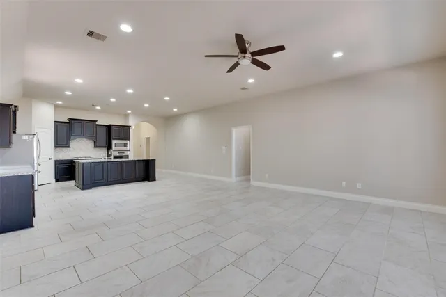 a view of a kitchen with a sink and stainless steel appliances