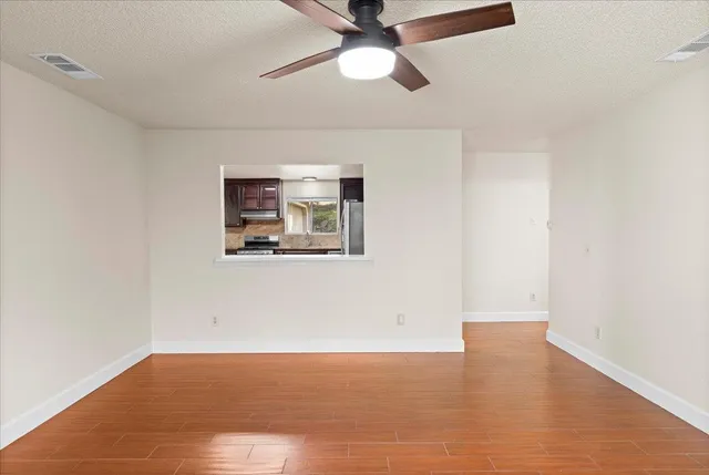 a kitchen with granite countertop stainless steel appliances and wooden cabinets