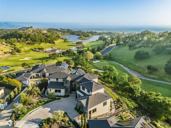 an aerial view of residential houses with outdoor space and river