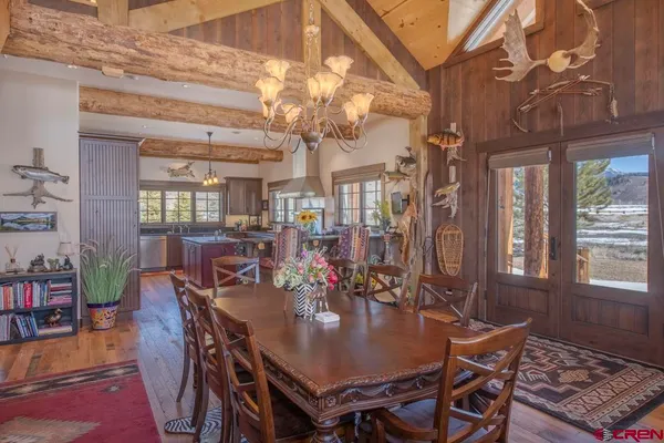 a kitchen with stainless steel appliances granite countertop a sink a stove and a wooden floors